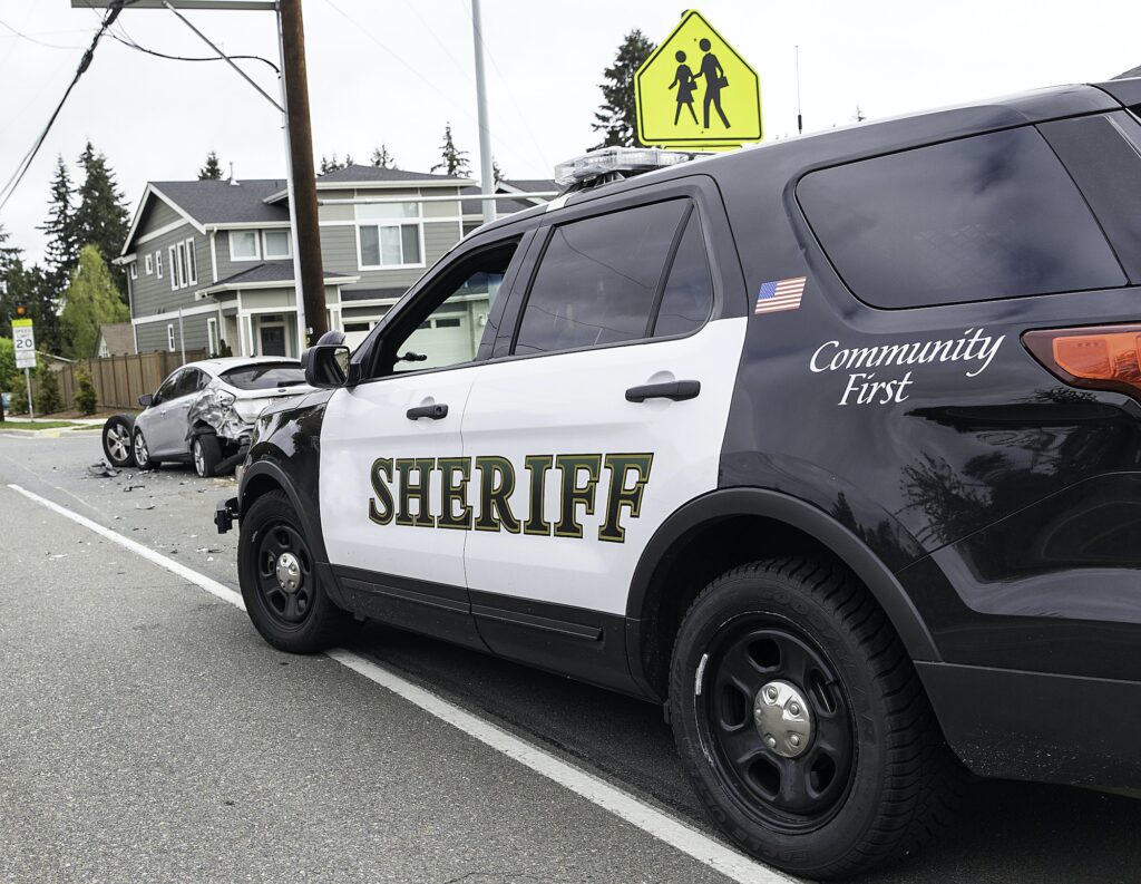 A sheriff parks behind the scene of an accident