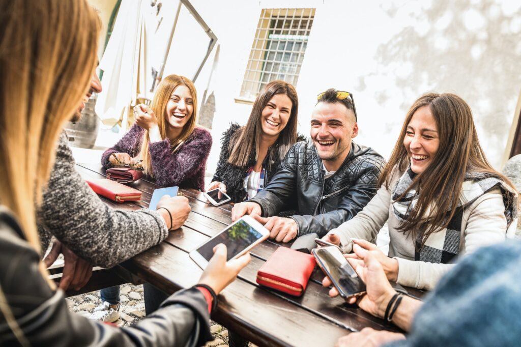 Millennial friends group having fun using mobile smart phone