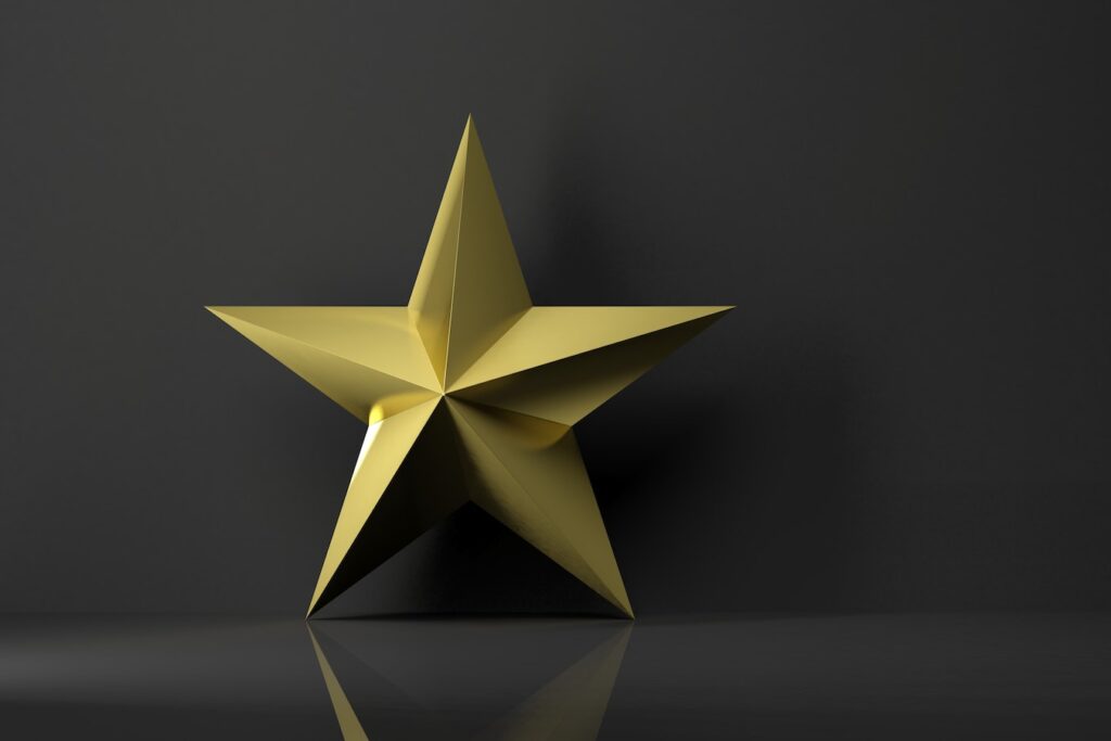 Golden star icon with reflection,isolated on black background